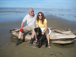 A dog with a man and a women