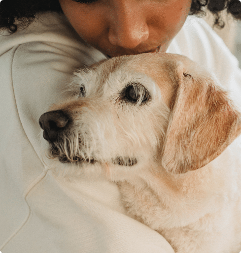 dog owner hugging her pet