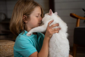 a girl hugging her cat